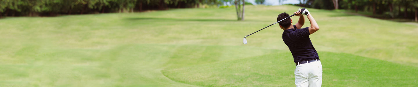 man swinging golf club