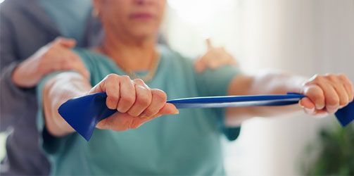 Woman stretching with physical therapist