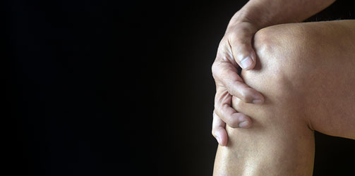 Hand holding knee Hand holding knee