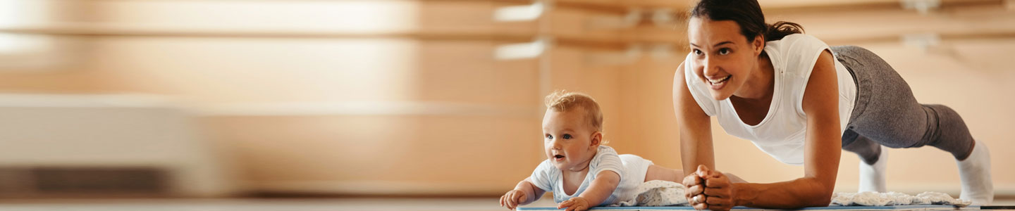 Mom in plank position next to baby